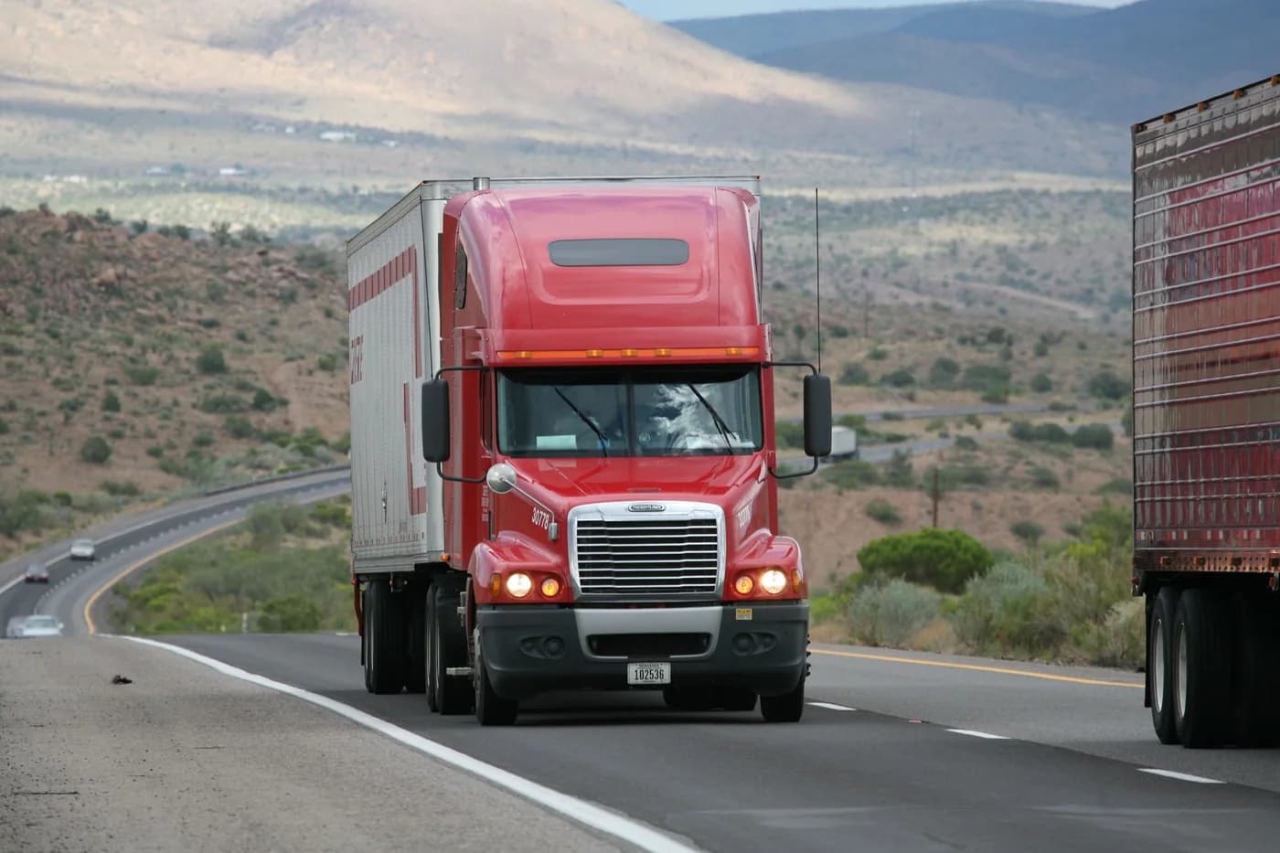Freight truck and trailer on a road.